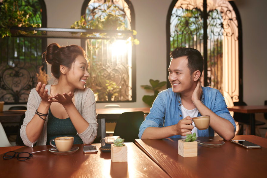 Asian Couple Chatting in Cafe Questions to Ask a Guy during coffee date
